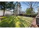 Expansive backyard features lush lawn, stepping stones, and mature trees for outdoor enjoyment at 1763 Delaware Ne Ave, Atlanta, GA 30307