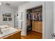 Bright bathroom boasts double sinks, tile shower and access to closet with custom shelving and storage at 1763 Delaware Ne Ave, Atlanta, GA 30307