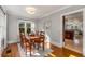Sunlit dining room with hardwood floors, large windows, light gray walls and a wooden table with chairs at 1763 Delaware Ne Ave, Atlanta, GA 30307