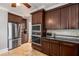 A modern kitchen featuring stainless steel appliances and plenty of dark brown cabinets with stone backsplash at 1763 Delaware Ne Ave, Atlanta, GA 30307