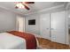 Modern main bedroom features hardwood floors, a ceiling fan, large windows, and a walk-in closet at 1763 Delaware Ne Ave, Atlanta, GA 30307