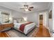 Spacious main bedroom featuring hardwood floors, a ceiling fan, large windows, a dresser, and a walk-in closet at 1763 Delaware Ne Ave, Atlanta, GA 30307