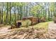 The house is nestled in the trees with a storage shed in the back at 2680 Irene Dr, Marietta, GA 30066