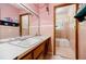 Retro pink bathroom featuring a large mirror and double sinks at 2680 Irene Dr, Marietta, GA 30066