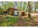 Exterior view of a house with overgrown yard and detached garage at 2680 Irene Dr, Marietta, GA 30066