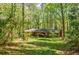 The brick house is surrounded by tall trees and landscaped grass at 2680 Irene Dr, Marietta, GA 30066