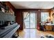 Living room featuring wood paneling, laminate wood flooring, and sliding glass doors to the exterior at 2680 Irene Dr, Marietta, GA 30066