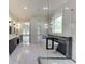 Spacious bathroom featuring marble tile, soaking tub, double vanity, and a separate glass-enclosed shower at 409 Thunder Rd, Buford, GA 30518