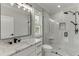 Modern bathroom with marble countertops, a large mirror, and a glass enclosed shower at 409 Thunder Rd, Buford, GA 30518