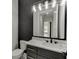 Bathroom vanity with marble countertop, undermount sinks, black fixtures and decorative lighting at 409 Thunder Rd, Buford, GA 30518
