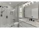This bathroom features an elegant white vanity with marble countertops and a sleek glass shower at 409 Thunder Rd, Buford, GA 30518