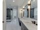 A spacious bathroom is designed with a double vanity, marble counters, and a glass shower at 409 Thunder Rd, Buford, GA 30518