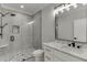 Modern bathroom with glass shower, rainfall shower head, and double vanity at 409 Thunder Rd, Buford, GA 30518