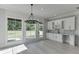 Bright dining area featuring a chandelier, wet bar, large windows, and backyard views at 409 Thunder Rd, Buford, GA 30518