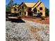 Exterior view of home under construction with exposed wood framing and a large lot at 409 Thunder Rd, Buford, GA 30518