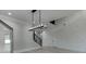 Grand foyer with an iron staircase, modern light fixture, wood floors, and white accent walls at 409 Thunder Rd, Buford, GA 30518