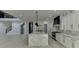 Bright, spacious kitchen with white cabinets, stainless steel appliances, and a large marble island at 409 Thunder Rd, Buford, GA 30518