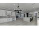 Spacious open-concept kitchen with marble countertops, stainless steel appliances, and a dining area at 409 Thunder Rd, Buford, GA 30518