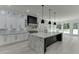 Well-lit kitchen with marble countertops, stainless steel appliances, black accents, and island at 409 Thunder Rd, Buford, GA 30518