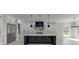 Modern kitchen boasts a stainless steel refrigerator, granite countertops, custom cabinets, and bright natural light at 409 Thunder Rd, Buford, GA 30518