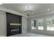 Living room offers a decorative chandelier, fireplace, large windows and light hardwood floors at 409 Thunder Rd, Buford, GA 30518