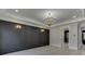 Spacious living room has a decorative chandelier, accent wall, with access to a bath at 409 Thunder Rd, Buford, GA 30518