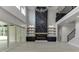 A spacious living room boasts a marble accent wall with a fireplace, custom shelves, and bright natural light at 409 Thunder Rd, Buford, GA 30518