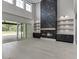 Living room boasts a marble accent wall with a fireplace, custom shelves, bright natural light and sliding glass doors at 409 Thunder Rd, Buford, GA 30518