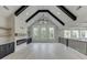 Spacious living room with vaulted ceilings, wood beams, fireplace, and modern chandelier at 409 Thunder Rd, Buford, GA 30518