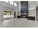 A bright living room boasts a marble accent wall with a fireplace, custom shelves, bright natural light and sliding glass doors at 409 Thunder Rd, Buford, GA 30518