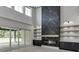 Living room boasts a marble accent wall with a fireplace, custom shelves, bright natural light and sliding glass doors at 409 Thunder Rd, Buford, GA 30518