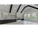 Bright living room with a modern fireplace, built-in cabinets, and large windows offering scenic views at 409 Thunder Rd, Buford, GA 30518