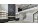 Spacious living room featuring a marble fireplace accent wall and access to the second story and hardwood floors at 409 Thunder Rd, Buford, GA 30518