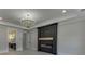 Bright living room with large fireplace, light hardwood floors, recessed lighting, and a view of the bath at 409 Thunder Rd, Buford, GA 30518