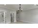 Spacious main bedroom featuring a chandelier and neutral walls at 409 Thunder Rd, Buford, GA 30518