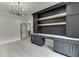 This office area features an elegant built in desk and shelving unit with a decorative light fixture at 409 Thunder Rd, Buford, GA 30518