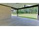 Covered patio overlooking a spacious lawn and fenced backyard at 409 Thunder Rd, Buford, GA 30518