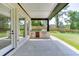 Covered patio with an outdoor kitchen and direct access to the backyard at 409 Thunder Rd, Buford, GA 30518