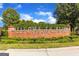 The community welcomes visitors to Buford's historic Main Street with a brick sign surrounded by greenery at 409 Thunder Rd, Buford, GA 30518