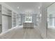 Expansive walk-in closet with custom shelving, central island with drawers, and contemporary lighting at 409 Thunder Rd, Buford, GA 30518