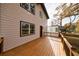 Wooden backyard deck featuring black railings and a view of the backyard at 676 S Grand Nw Ave, Atlanta, GA 30318