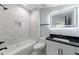 Clean bathroom with a marble-tiled wall and a shower-tub combo at 676 S Grand Nw Ave, Atlanta, GA 30318