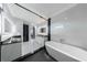 Elegant bathroom with a soaking tub, modern fixtures, and sleek black and white design at 676 S Grand Nw Ave, Atlanta, GA 30318