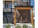 Front exterior featuring a covered entryway, modern garage door, and a combination of wood and dark siding at 676 S Grand Nw Ave, Atlanta, GA 30318