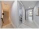 Hallway with light gray walls, light wood floors, modern lighting, and black doors leading to other rooms at 676 S Grand Nw Ave, Atlanta, GA 30318