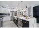 Gourmet kitchen with custom cabinets, stainless steel appliances, and a large quartz island at 676 S Grand Nw Ave, Atlanta, GA 30318
