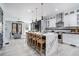 Modern kitchen with a large waterfall island, pendant lights, and stainless steel appliances at 676 S Grand Nw Ave, Atlanta, GA 30318