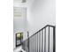 View of a modern staircase with metal railings and a decorative chandelier above at 676 S Grand Nw Ave, Atlanta, GA 30318