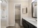 Bathroom with a shower-tub combo and a vanity next to the walk-in closet entry at 2605 Vineyard Se Way, Smyrna, GA 30082