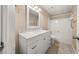 Bright bathroom featuring a white vanity with a marble countertop and a shower-tub combo at 2605 Vineyard Se Way, Smyrna, GA 30082